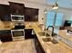 Modern kitchen features dark cabinetry, stainless steel appliances, and granite countertops at 3325 Pintello Ave, New Smyrna Beach, FL 32168