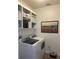 Laundry room with a washer and dryer, featuring storage shelves, providing a functional space at 3325 Pintello Ave, New Smyrna Beach, FL 32168