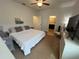Comfortable bedroom with neutral tones, a ceiling fan, and an ensuite bathroom at 3325 Pintello Ave, New Smyrna Beach, FL 32168