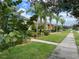 Sidewalk view of homes with lush landscaping at 3325 Pintello Ave, New Smyrna Beach, FL 32168