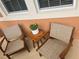 Patio with two chairs and a small table, creating a comfortable and inviting outdoor living space at 3325 Pintello Ave, New Smyrna Beach, FL 32168