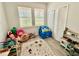 Bright playroom featuring two windows, play kitchen, carpet, and a closet at 3325 Pintello Ave, New Smyrna Beach, FL 32168