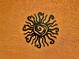 Detailed image of a black sunburst metal art piece affixed to a textured orange wall at 3325 Pintello Ave, New Smyrna Beach, FL 32168