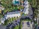 Overhead view of townhomes with parking, a pool, and green space at 4017 Saxon Dr, New Smyrna Beach, FL 32169