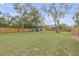 Expansive backyard features lush green grass, a newly constructed wooden fence, and mature trees at 532 Faulkner St, New Smyrna Beach, FL 32168