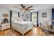 Bright bedroom with hardwood flooring, ceiling fan, natural light, and white walls at 532 Faulkner St, New Smyrna Beach, FL 32168