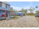 Paved driveway leads to a charming blue home with a screened-in pool and a detached garage at 532 Faulkner St, New Smyrna Beach, FL 32168