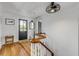 Entryway featuring a staircase, hardwood floors, black front door, white walls, and stylish lighting at 532 Faulkner St, New Smyrna Beach, FL 32168