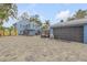 Stunning two-story blue home featuring a paved driveway, lush landscaping, and a convenient attached garage at 532 Faulkner St, New Smyrna Beach, FL 32168