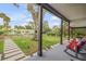 Inviting front porch with rocking chairs, lush lawn, charming landscaping, and great curb appeal at 532 Faulkner St, New Smyrna Beach, FL 32168