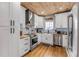 Stylish kitchen with white cabinetry, stainless steel appliances, and wood accents, offering modern convenience at 532 Faulkner St, New Smyrna Beach, FL 32168