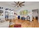 Open-concept living room with hardwood floors and high ceilings, flowing into the dining and kitchen areas at 532 Faulkner St, New Smyrna Beach, FL 32168
