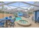 Gorgeous enclosed pool with spa, dining set, and vibrant mural creating a perfect outdoor oasis at 532 Faulkner St, New Smyrna Beach, FL 32168
