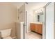 Bathroom with wood cabinets and a glass shower at 6793 Calistoga Cir, Port Orange, FL 32128