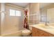 Bright bathroom featuring a shower-tub combo, white cabinets, and neutral walls at 6793 Calistoga Cir, Port Orange, FL 32128