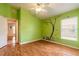 Charming bedroom with wood floors, natural light, and playful decor at 6793 Calistoga Cir, Port Orange, FL 32128