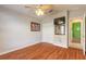 Bedroom featuring wood floors, ceiling fan, neutral colored walls, closet and mounted tv at 6793 Calistoga Cir, Port Orange, FL 32128