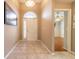 Bright entryway featuring tile floors and a transom window above the white front door at 6793 Calistoga Cir, Port Orange, FL 32128