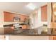 Updated kitchen featuring granite countertops, a breakfast bar, and stainless steel appliances at 6793 Calistoga Cir, Port Orange, FL 32128