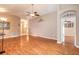 Open-concept living room with wood floors, neutral walls, and arched doorway at 6793 Calistoga Cir, Port Orange, FL 32128