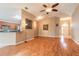 Open-concept living room with wood floors, an arched entryway, and easy access to the kitchen at 6793 Calistoga Cir, Port Orange, FL 32128