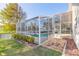 Inviting screened-in pool area with views of the backyard and landscaping at 6793 Calistoga Cir, Port Orange, FL 32128