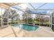 Screened-in pool and patio area with views of the surrounding landscape at 6793 Calistoga Cir, Port Orange, FL 32128