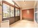 Enclosed sunroom featuring tile flooring, lots of windows and natural light, and backyard view at 6793 Calistoga Cir, Port Orange, FL 32128