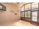 Enclosed sunroom featuring tile flooring, ceiling fan, and expansive windows with backyard view at 6793 Calistoga Cir, Port Orange, FL 32128