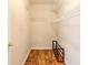 Walk-in closet with wood floors, white walls and wire rack shelving at 6793 Calistoga Cir, Port Orange, FL 32128