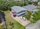 Aerial view of a two-story home with light-blue siding, a garage door, and a pool nearby at 824 Garfish Ave, New Smyrna Beach, FL 32169