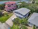 Aerial view of a two-story home with light-blue siding, a garage door, near water at 824 Garfish Ave, New Smyrna Beach, FL 32169