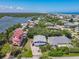 Aerial view of a neighborhood surrounding a two-story home with light-blue siding, and water at 824 Garfish Ave, New Smyrna Beach, FL 32169
