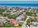 Aerial view of a neighborhood surrounding a two-story home with light-blue siding, near the ocean at 824 Garfish Ave, New Smyrna Beach, FL 32169