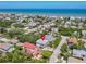 Aerial view of a neighborhood surrounding a two-story home with light-blue siding, ocean in background at 824 Garfish Ave, New Smyrna Beach, FL 32169