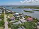 An aerial view captures the neighborhood setting of a waterfront community with tranquil waterways at 824 Garfish Ave, New Smyrna Beach, FL 32169