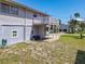 Backyard and exterior featuring a deck, grassy lawn, and easy access to off-street parking at 824 Garfish Ave, New Smyrna Beach, FL 32169