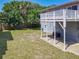 This home features a spacious backyard with a deck and lush greenery, perfect for outdoor living at 824 Garfish Ave, New Smyrna Beach, FL 32169