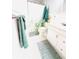 Bright bathroom featuring a white vanity, decorative shower curtain and stylish coordinating green bathmats and towels at 824 Garfish Ave, New Smyrna Beach, FL 32169