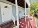 Covered patio with table and chairs offering an inviting outdoor dining and relaxation space at 824 Garfish Ave, New Smyrna Beach, FL 32169