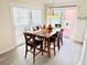 Bright dining room features a wooden table with six chairs and sliding glass doors for ample natural light at 824 Garfish Ave, New Smyrna Beach, FL 32169