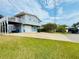 Charming coastal home with a spacious front yard, two-car garage, and upper deck at 824 Garfish Ave, New Smyrna Beach, FL 32169