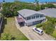 Two-story home with light-blue siding, a white garage door, and a long driveway at 824 Garfish Ave, New Smyrna Beach, FL 32169