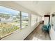 Light-filled sunroom with large windows offering views of the surrounding neighborhood at 824 Garfish Ave, New Smyrna Beach, FL 32169
