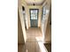 Front entry with light teal door and tile floor at 131 W Palm Way, Edgewater, FL 32132