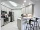 Modern kitchen with breakfast bar, stainless steel appliances, and light gray cabinets at 2 Riverwalk Dr # 302, New Smyrna Beach, FL 32169