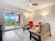 Living room with balcony access and comfortable seating at 2 Riverwalk Dr # 302, New Smyrna Beach, FL 32169