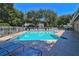 Community pool with plenty of lounge chairs and shade for relaxing by the poolside at 4411 Sea Mist Ct # 275, New Smyrna Beach, FL 32169