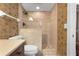 Bathroom featuring a tiled shower with glass door, dark fixtures, patterned walls, and toilet at 4621 S Atlantic Ave # 7101, Ponce Inlet, FL 32127