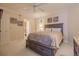 A comfortable bedroom with a wooden bed frame, soft lighting, ceiling fan, and nautical themed wall art at 4621 S Atlantic Ave # 7101, Ponce Inlet, FL 32127